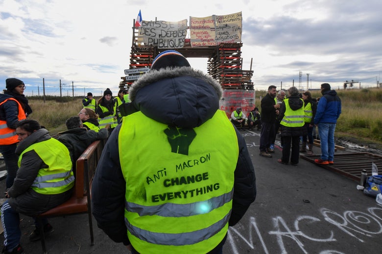 Yellow vests (Gilets jaunes) protesters block the road leading to the Frontignan oil depot in the south of France, as they demonstrate against the rise in fuel prices and the cost of living on December 3, 2018. - Dozens of French 'yellow vest' demonstrators blocked access to a major fuel depot and several highways on the third week of anti-government protests which led to major riots in Paris at the weekend. (Photo by PASCAL GUYOT / AFP) (Photo credit should read PASCAL GUYOT/AFP/Getty Images)